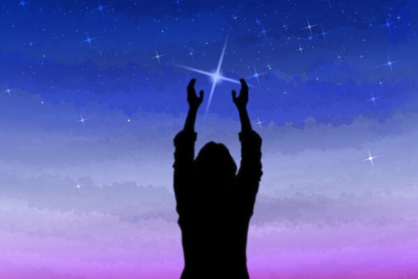 woman's silhouette reaching up to the brightest star.